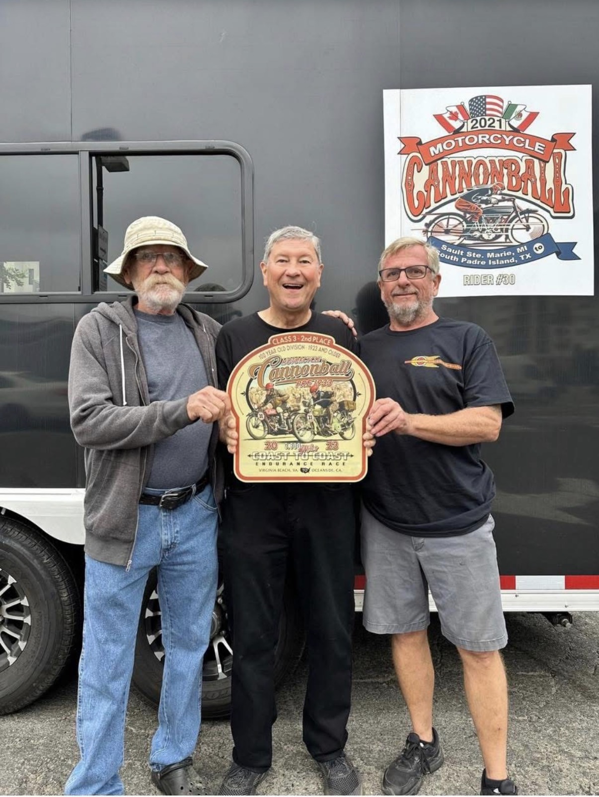 Tommy with friends and the Motorcycle Cannonball endurance race award