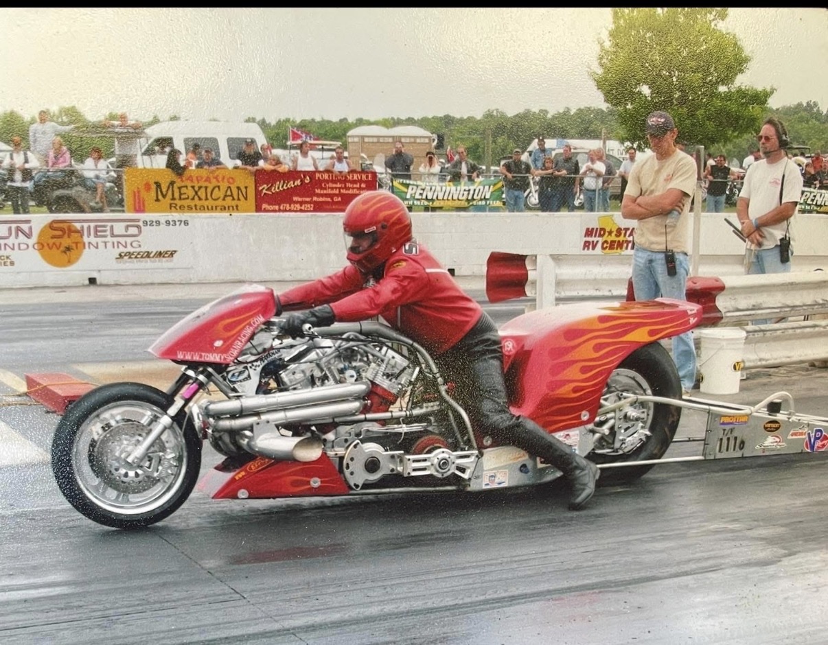 Tommy launching his flamed nitro V-twin drag bike at the strip