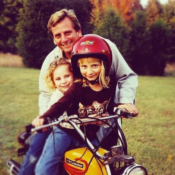 Tommy riding with his daughters on a vintage Harley-Davidson